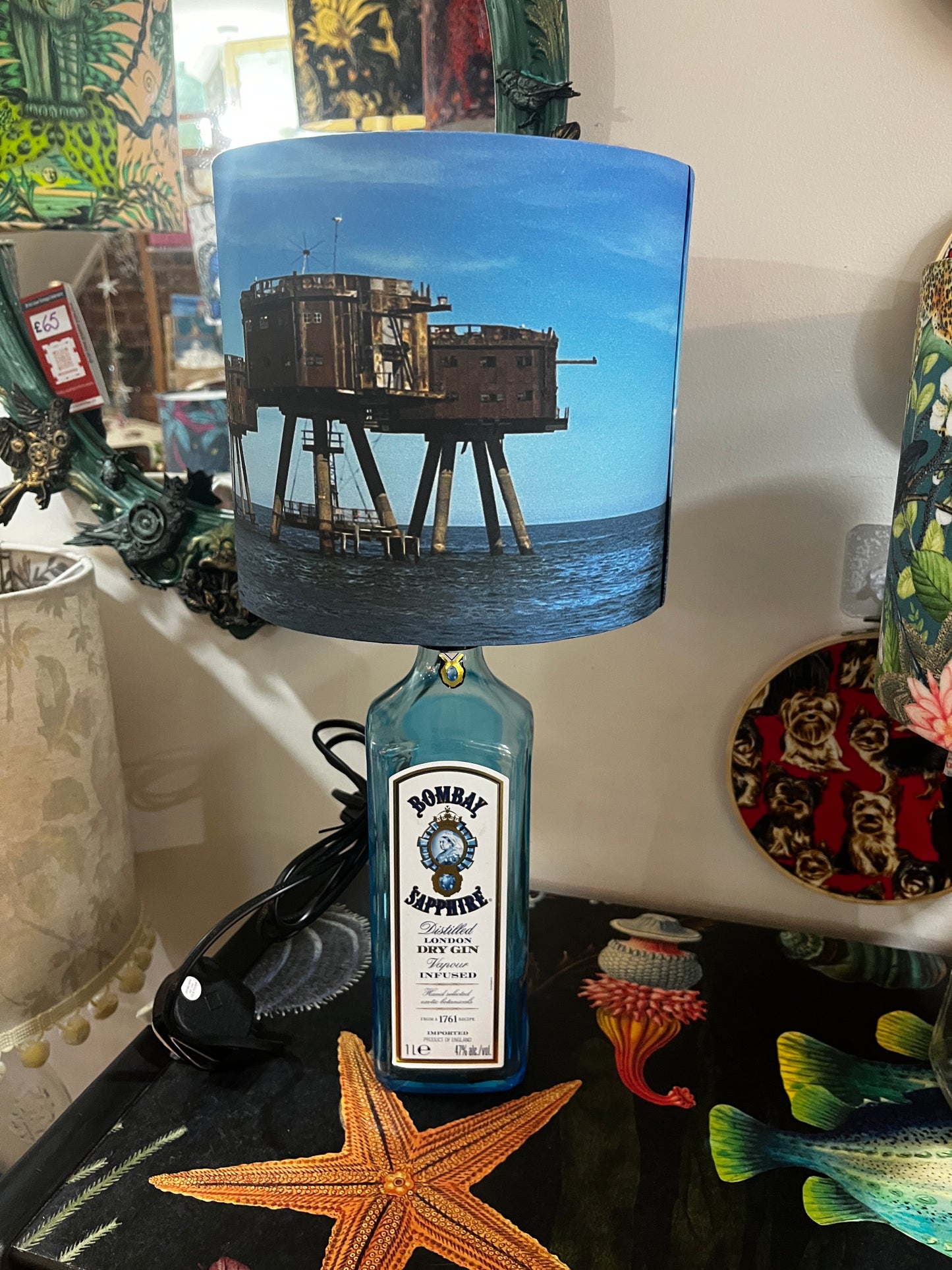 Upcycled Bombay Sapphire Gin Bottle lamp with Handmade 20cm Lampshade with the Whitstable Red Sands Maunsell Forts.