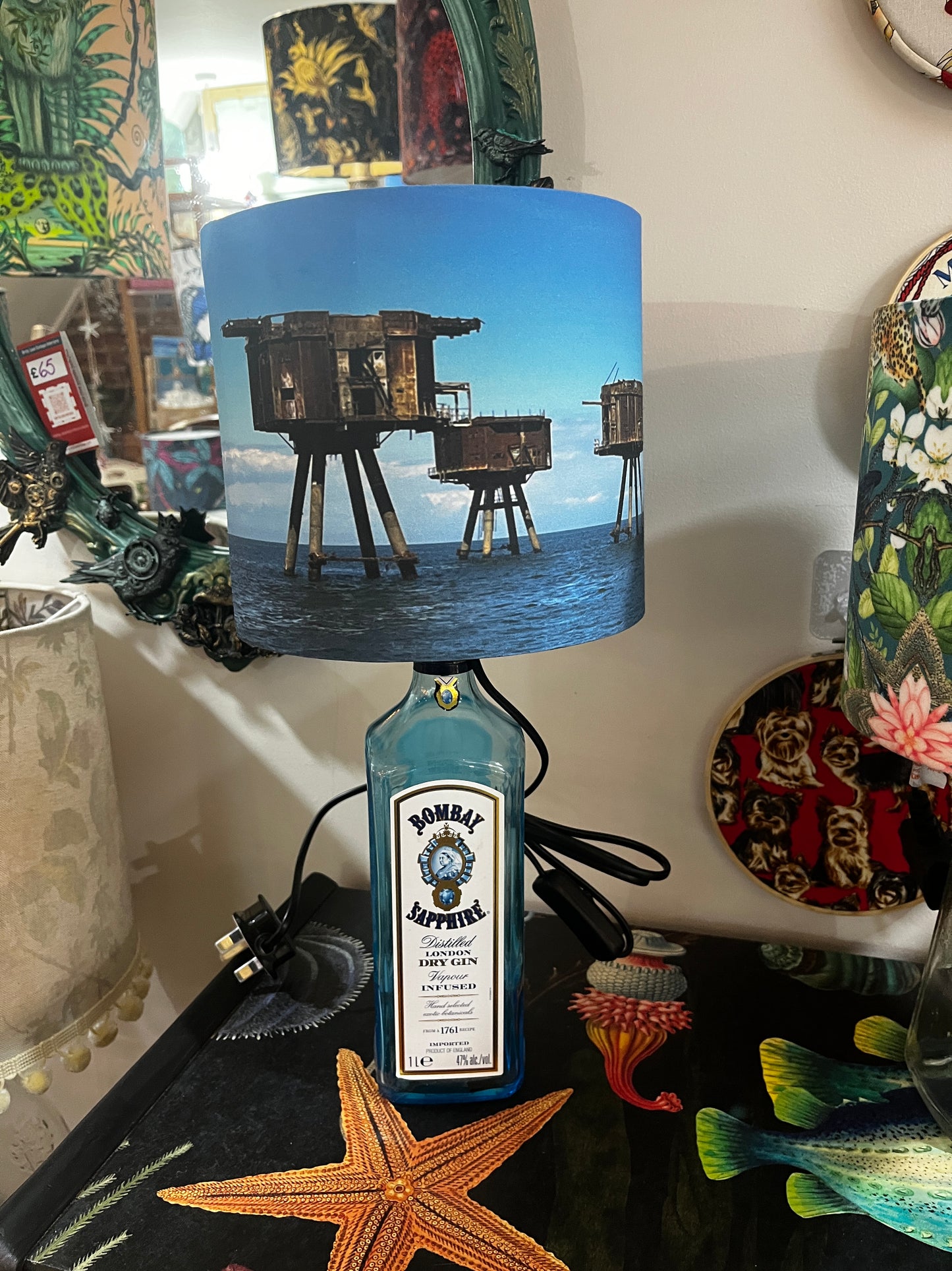 Upcycled Bombay Sapphire Gin Bottle lamp with Handmade 20cm Lampshade with the Whitstable Red Sands Maunsell Forts.