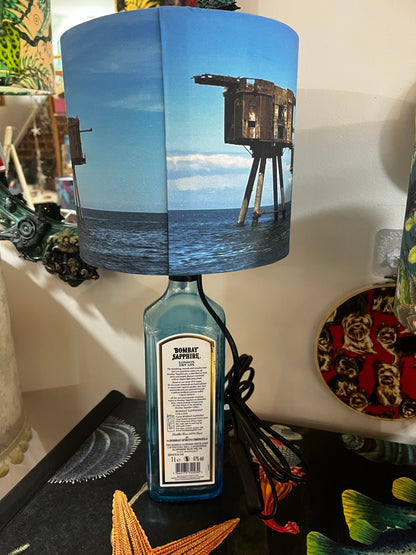 Upcycled Bombay Sapphire Gin Bottle lamp with Handmade 20cm Lampshade with the Whitstable Red Sands Maunsell Forts.